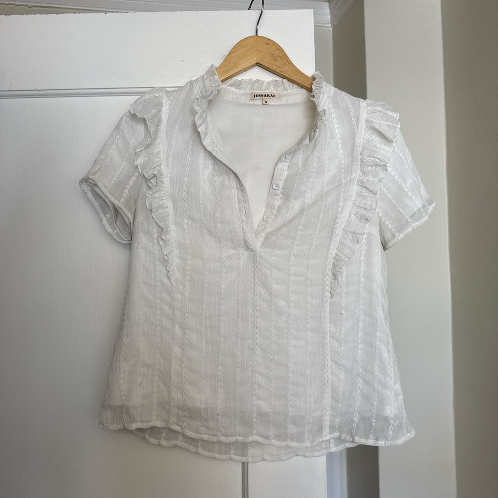 White ruffled blouse with short sleeves